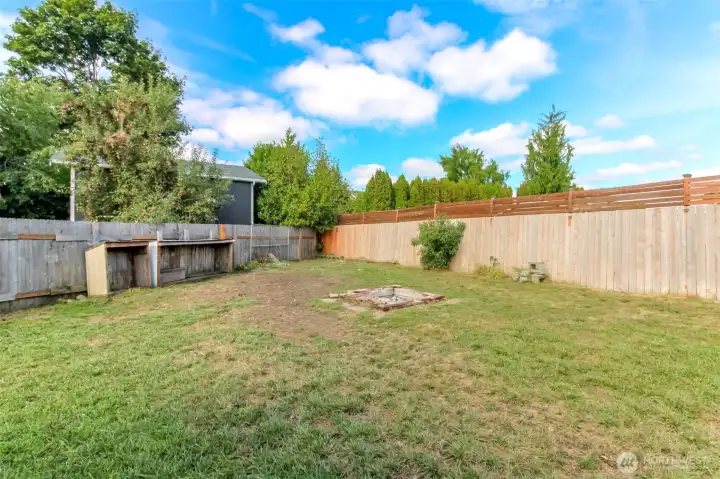 Huge backyard with firepit.