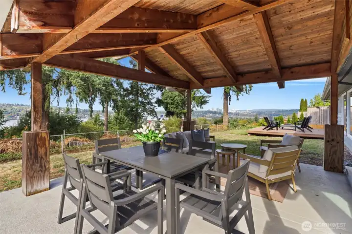 Backyard with multiple entertaining areas including covered patio
