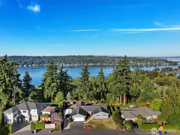 Aerial view of home with lake and city skyline views