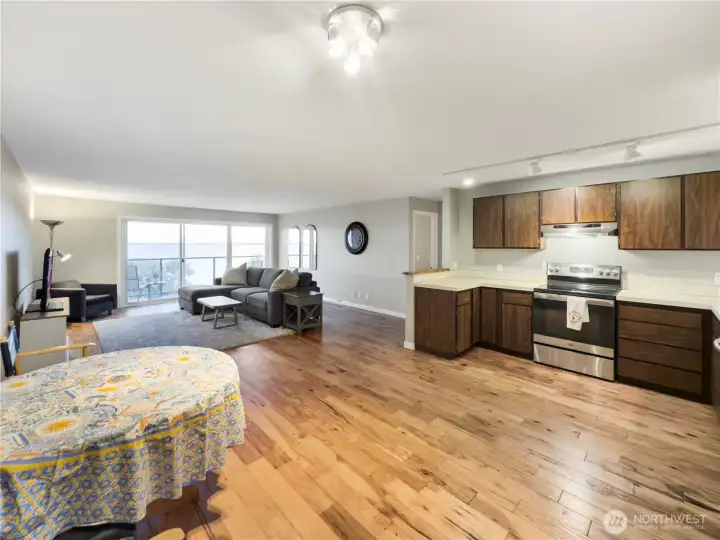 Open concept kitchend flows into the living area with upgraded flooring.