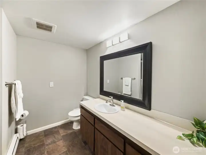 Restroom with nice lights and large mirror.