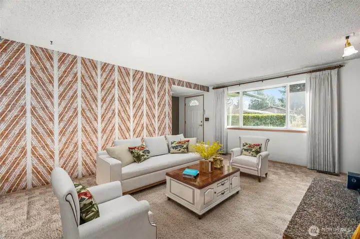 Living room with wood burning fireplace. (staged)