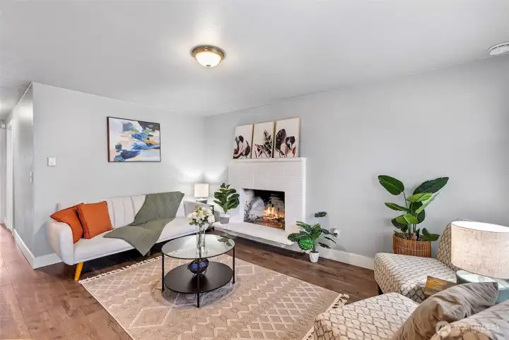 Living room with wood burning fireplace.