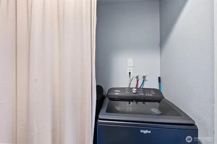 Laundry in hallway utility closet.