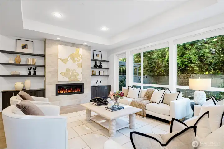 Living room with walls of windows and connecting to a private backyard