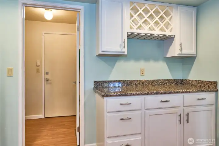 The kitchen also features a built in wine rack and beverage bar with more storage space.