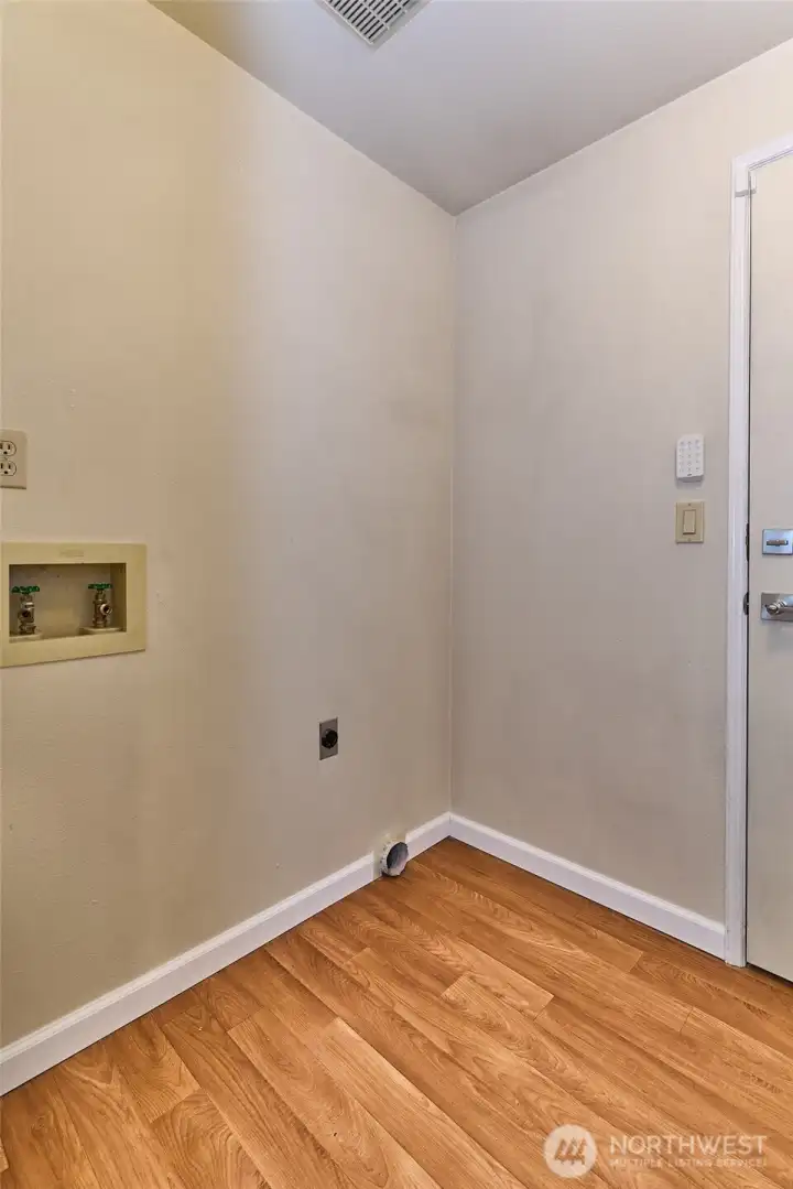 The main floor utility room reveals new flooring.