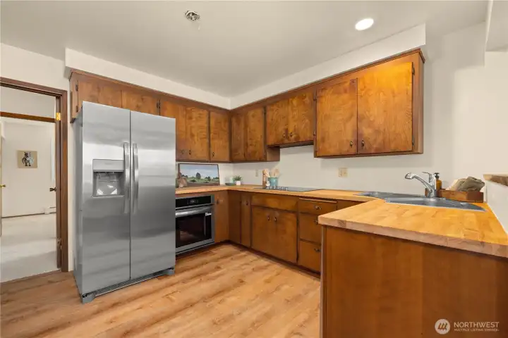 Kitchen features new appliances, flooring and countertops.