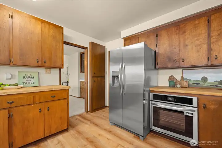 New fridge and stove along with the mid century vibes. New paint and flooring.