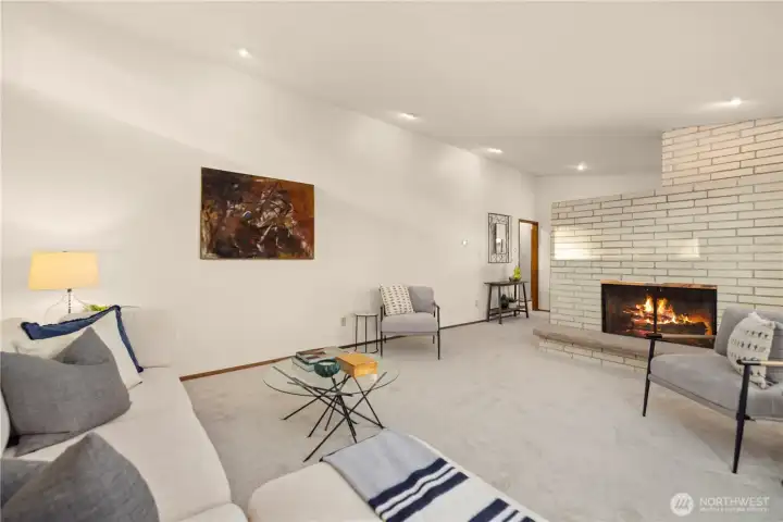 Upstairs living room has a cozy wood burning fireplace. New paint and carpet.