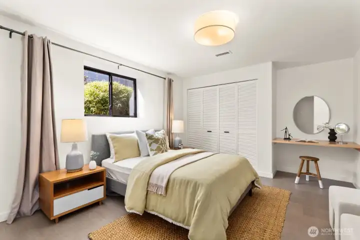 Go down another 1/2 level and you'll find the amazing guest en-suite. This large bedroom has a built-in desk as well!