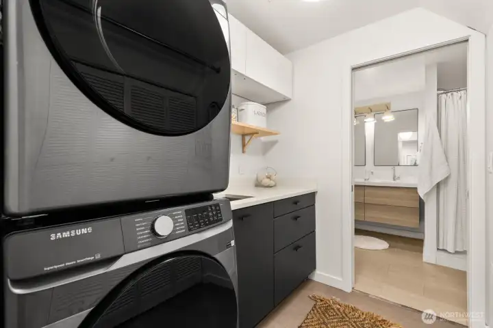 The laundry room is accessed from the hallway, but is also connected to the bathroom.