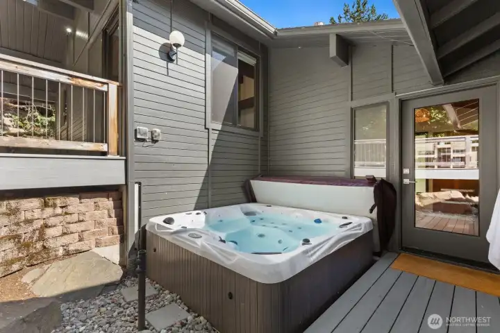 The hot tub is extremely private and access just off of the interior. Note the TV stand already installed here!