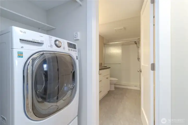 Washer dryer combo just across the hall from bedrooms, adjacent a large closet running the length of hallway