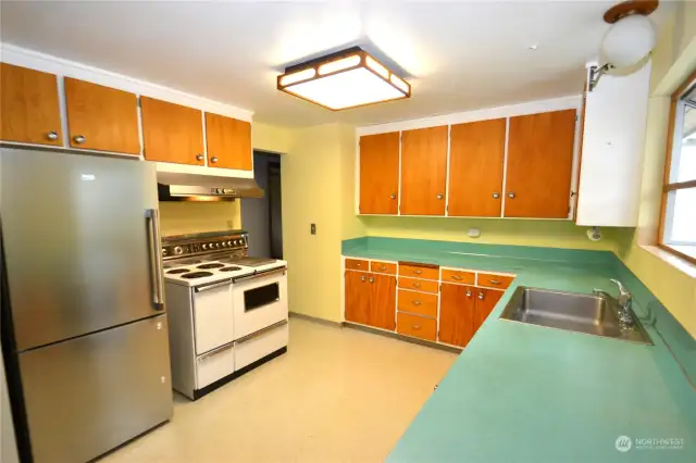 Big kitchen with original cabinets and original stove