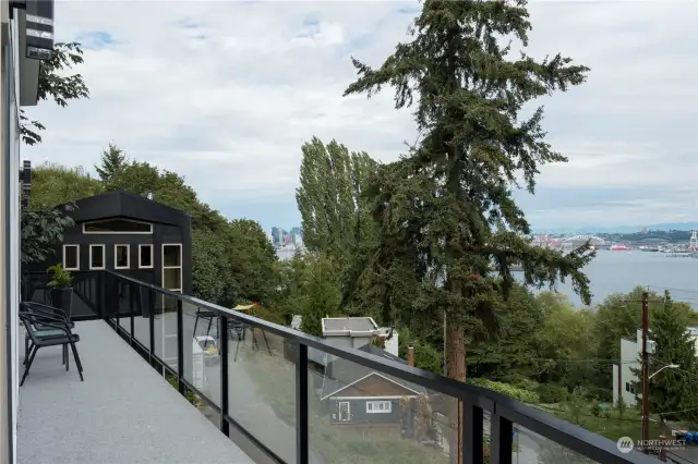 Three decks extend across front of house providing tons of natural light inside and plenty of outdoor options to enjoy sun, shade and views