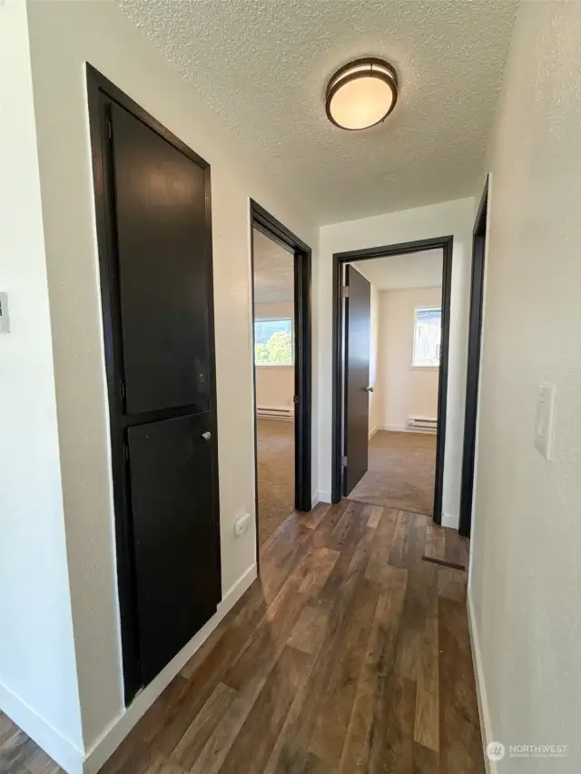 Hallway w/closet and entrance to two bedrooms + bathroom