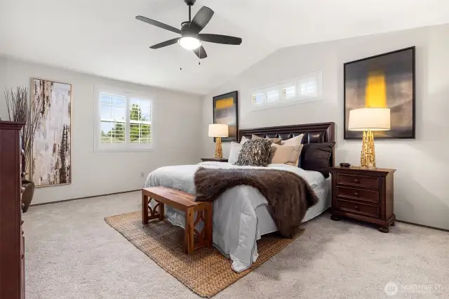 Primary bedroom w/ vaulted ceilings, and ensuite bathroom!