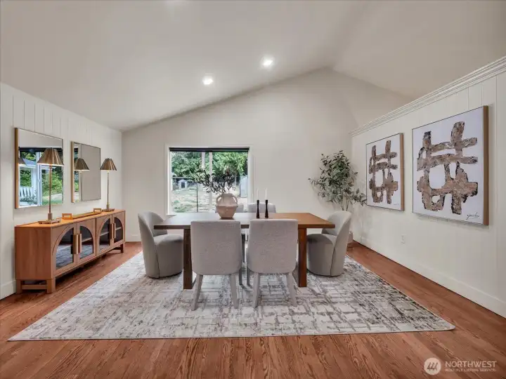 Open concept dining room with vaulted ceiling and natural light