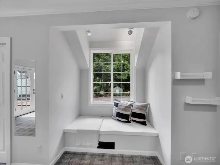Cozy window nook with forest views and built-in seating