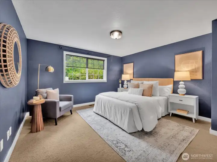 Stylish bedroom with bold navy walls and natural light