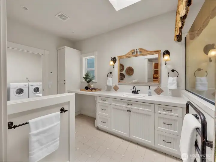 Bathroom with dual vanity, vintage accents, and ample storage
