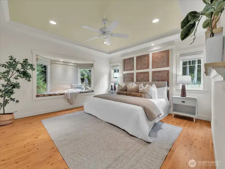 Luxurious primary suite with window seat and custom wall detail