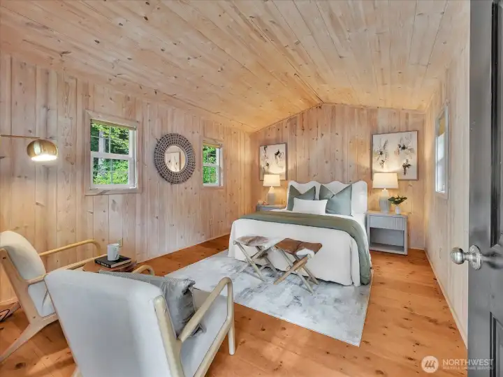 Rustic guest cottage bedroom with warm cedar tongue and grove