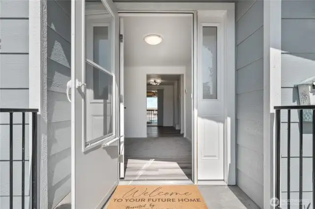 Charming, covered front porch with a welcoming entry and screened storm door