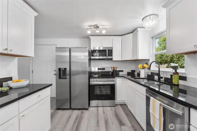 Expansive luxury kitchen with custom cabinetry, granite counters, and premium stainless appliances