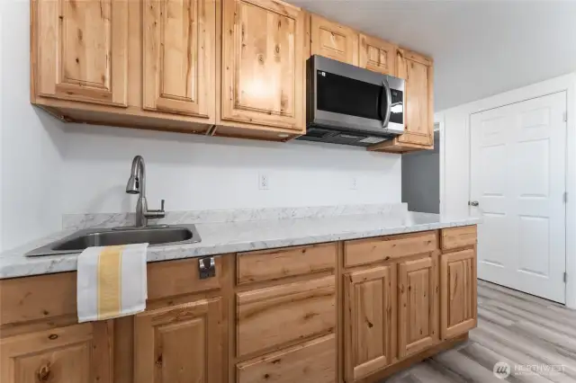 Whether hosting extended family or generating rental income, the lower level delivers with two bedrooms, a full kitchen, oversized living room, storage, a bathroom and separate entry