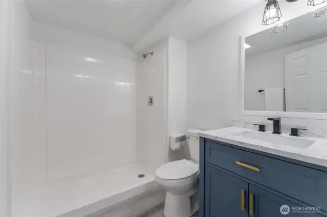 Beautifully finished lower-level bathroom with easy-access walk-in shower and contemporary design