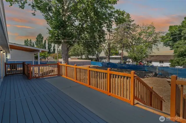 Oversized deck, terraced yard, and flexible layout with two kitchens make this 5BR/3BA home a smart investment or multi-gen haven