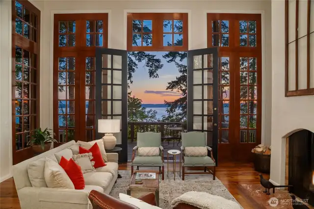 Custom 14 foot wood framed window wall with centered French doors provides abundant natural light and frames sweeping views of the forest and the waters of Port Susan.