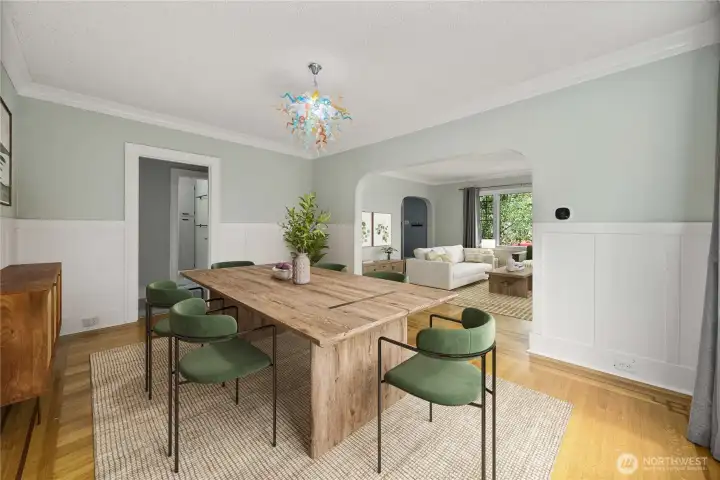 Formal dining room with view of hardwood floors and wainscotting