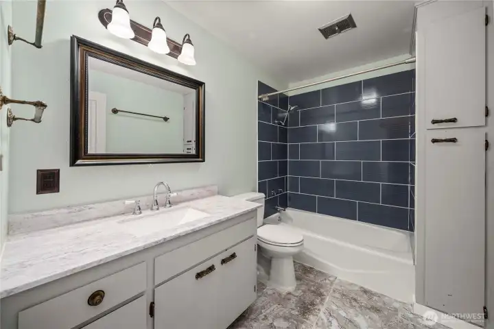 Updated main floor hall bathroom sits between the 2 main floor bedrooms