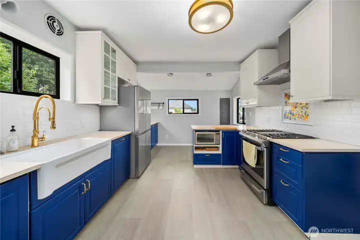 updated spacious kitchen with farmers sink and gas stove.