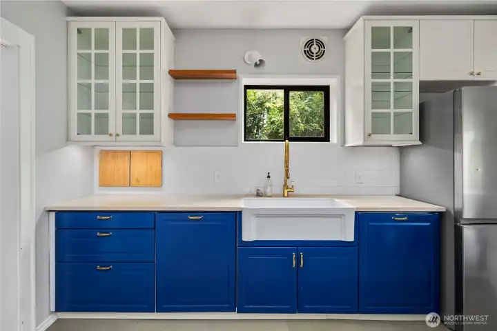 Solid surface counters, farmers kitchen over-looking south side yard of home