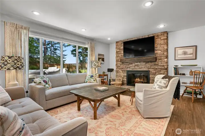Isn't this living room inviting?  That's a double-sided fireplace, those picture windows make the sunsets amazing!