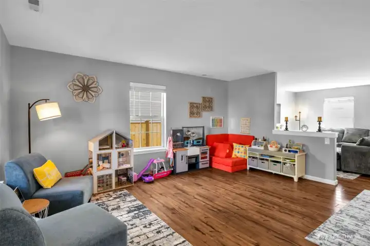 Living room, tons of windows and half wall separating.