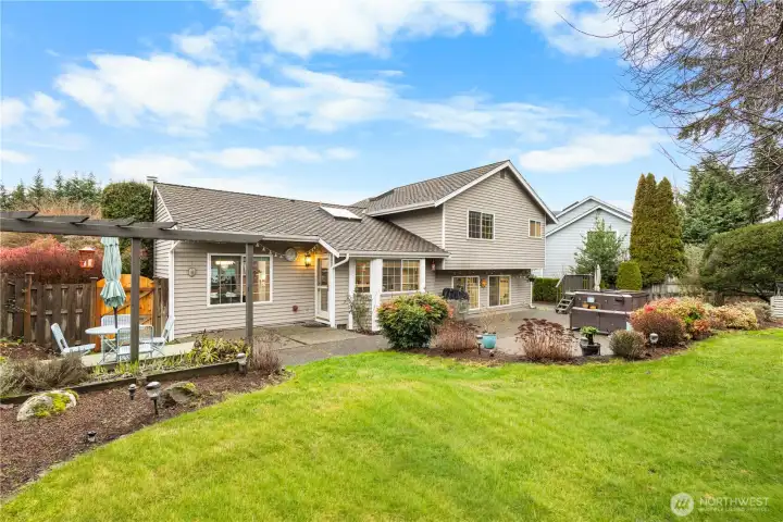 An oasis for outdoor living and fun: patios, garden area, fenced in for your four-legged friends, and a hot tub for relating. There is a gas stub for your BBQ.