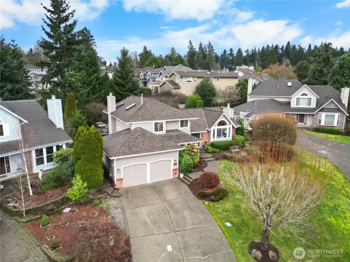 The property is sited at the end of the cul-de-sac with a long driveway for extra parking, front lawn and attached two car garage with E/V charging.