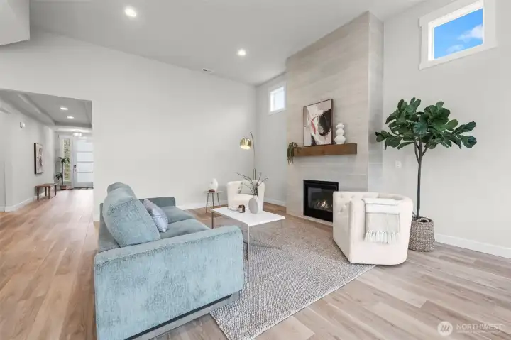 Cozy living room retreat within the open-concept layout, filled with natural light and anchored by upgraded finishes that create a warm gathering space in this newer construction McCormick Trails home.