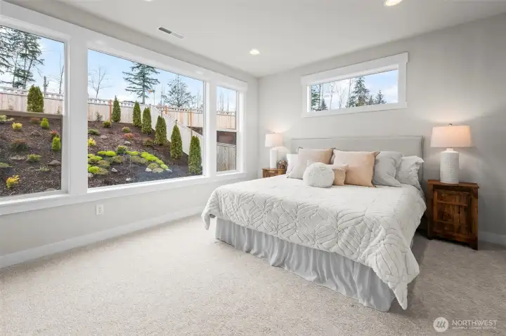 Spacious primary bedroom retreat filled with natural light, offering a peaceful escape within this upgraded newer construction home in McCormick Trails, Port Orchard, designed for comfortable single-level living.