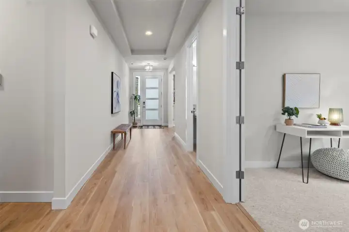 Wide hallway leading toward the front entry, showcasing the spacious single-level layout and thoughtful design found throughout this upgraded newer construction home in McCormick Trails, Port Orchard.