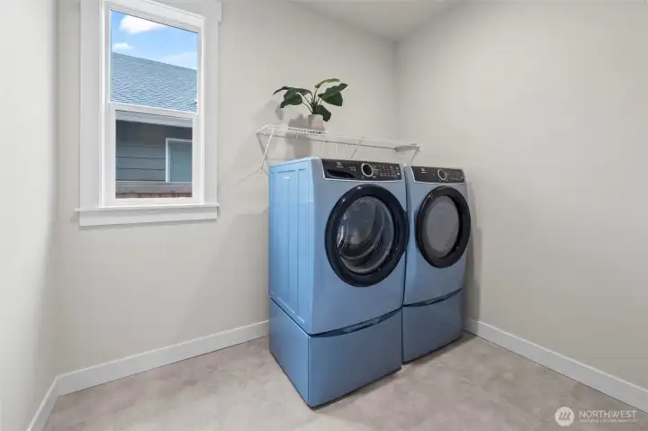 Dedicated laundry room featuring high-end washer and dryer included with the home, adding everyday convenience to this thoughtfully upgraded newer construction layout in McCormick Trails, Port Orchard.
