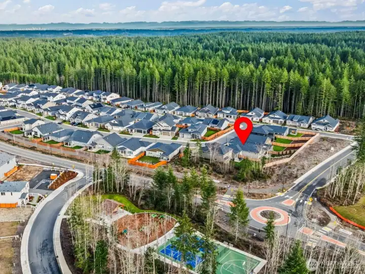 Aerial view of the McCormick Trails community highlighting miles of scenic pathways, nearby golf, and easy access to water activities — home built in 2025 within this sought-after Port Orchard neighborhood.