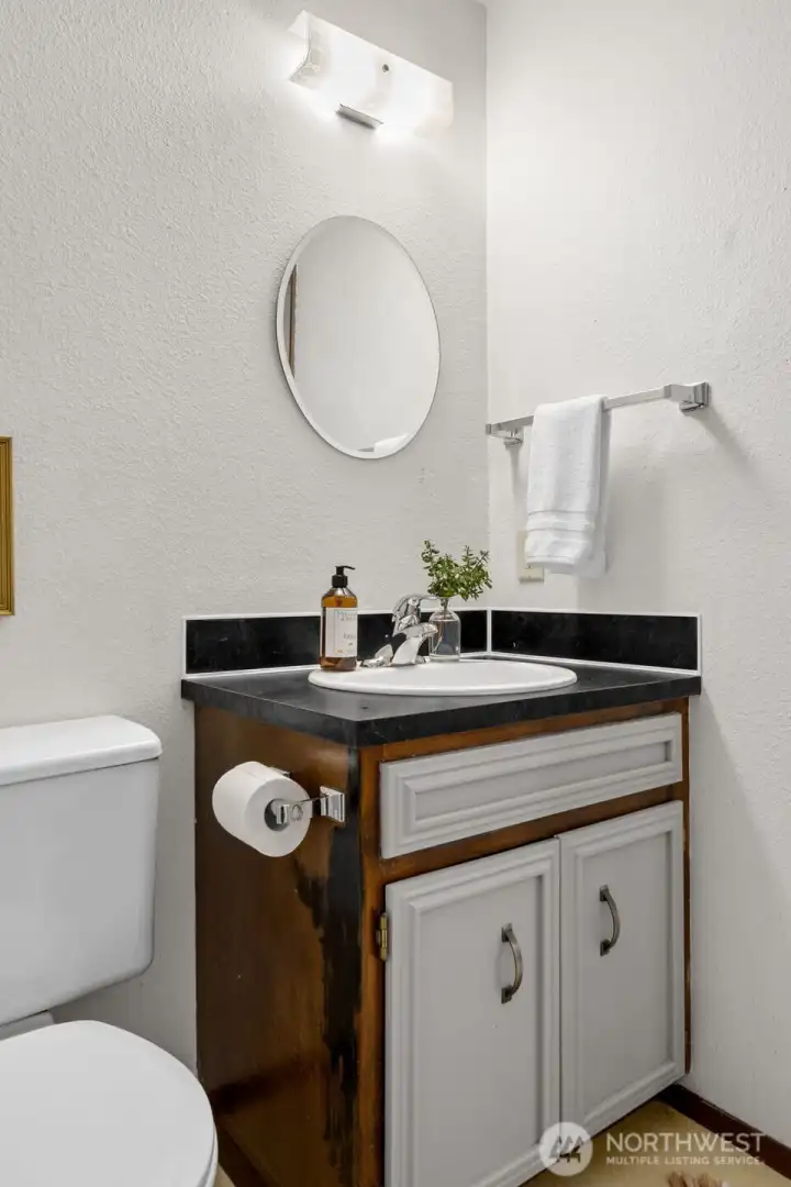 Half bathroom off second living area is perfectly situated for guests and personal usage