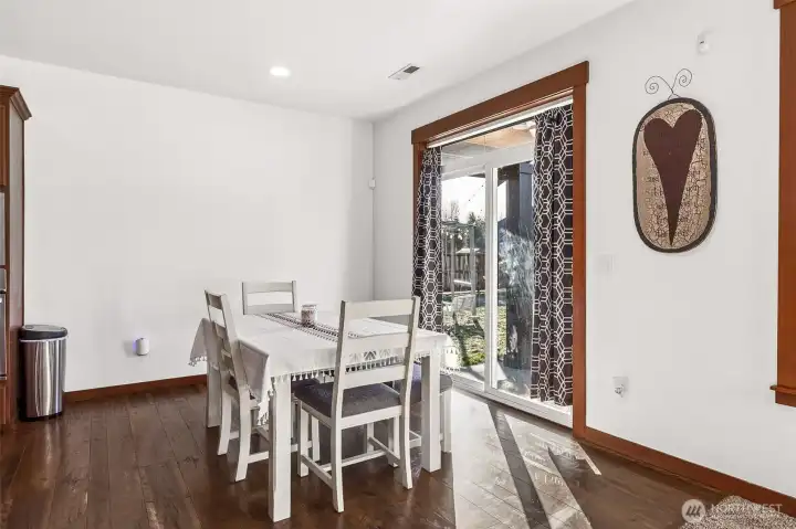 dining space leading off to backyard patio and fire pit area