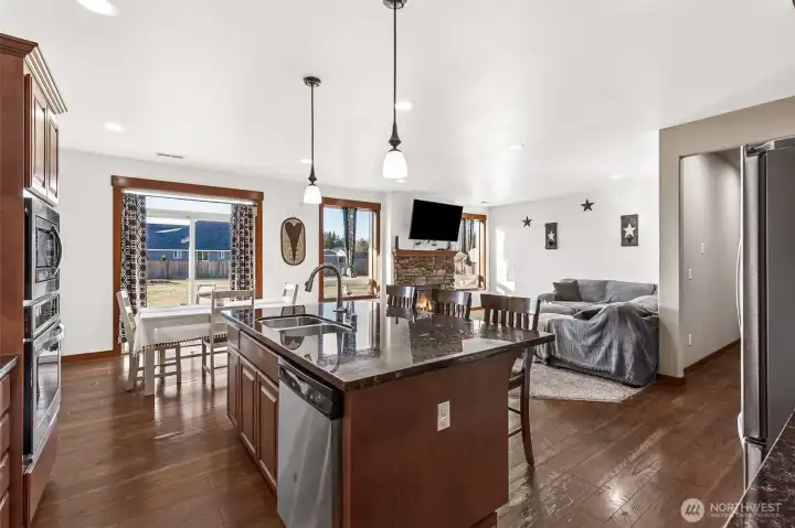 combination picture of kitchen, eat in and living room